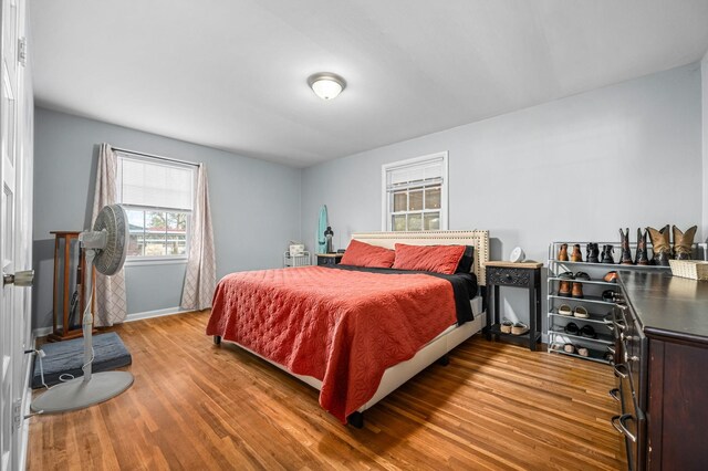 bedroom featuring baseboards and wood finished floors