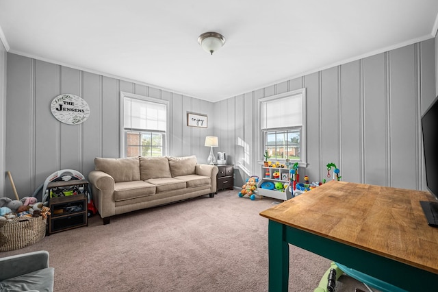 carpeted living room with a decorative wall and crown molding