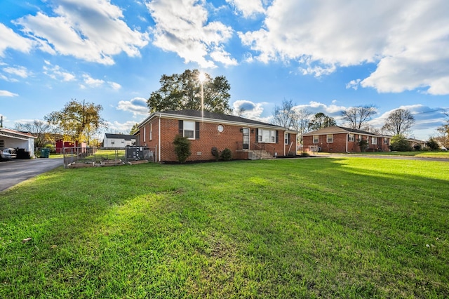 exterior space with brick siding and a lawn