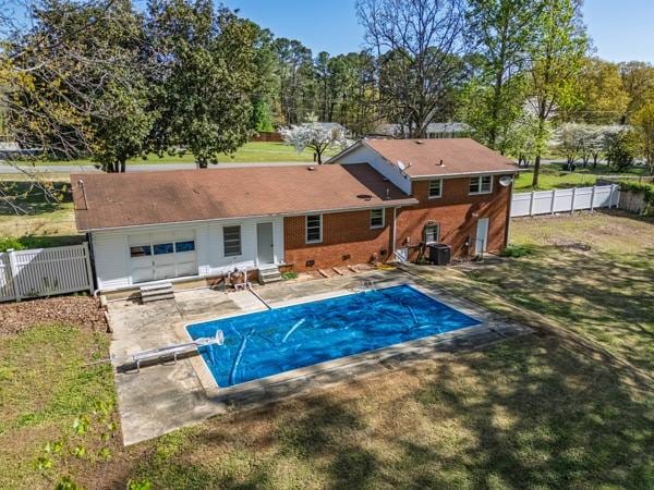 rear view of house featuring entry steps, fence, a yard, and a patio
