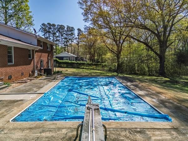 view of swimming pool with a covered pool