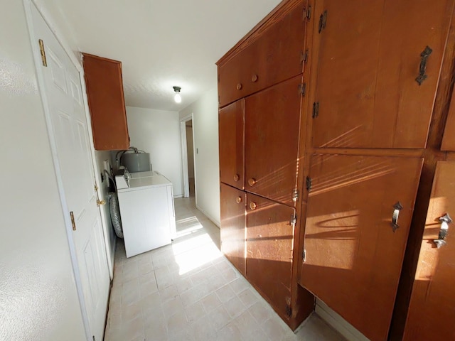 washroom featuring light floors, cabinet space, and washer / dryer