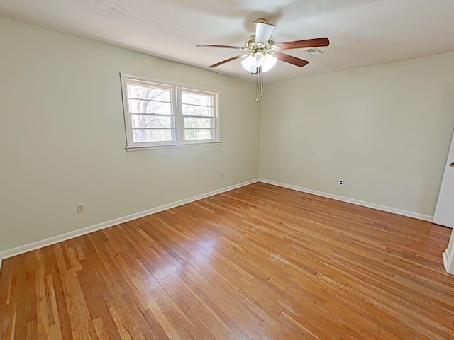 unfurnished room featuring visible vents, light wood-type flooring, baseboards, and ceiling fan