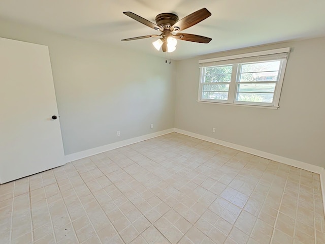 unfurnished room featuring ceiling fan and baseboards