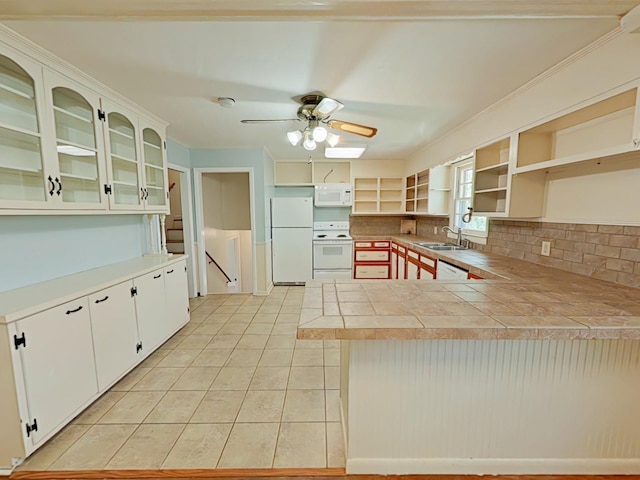 kitchen with open shelves, a sink, white appliances, a peninsula, and light tile patterned flooring