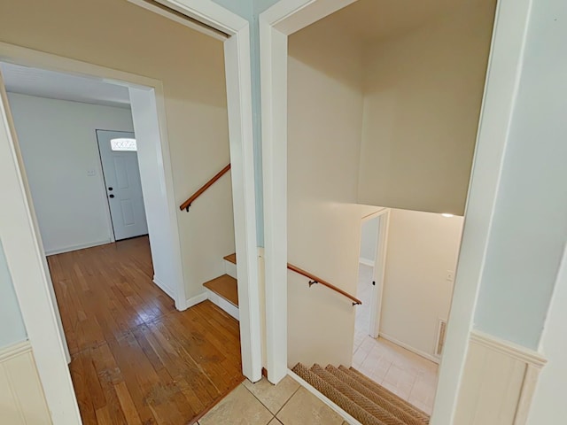 staircase with hardwood / wood-style floors