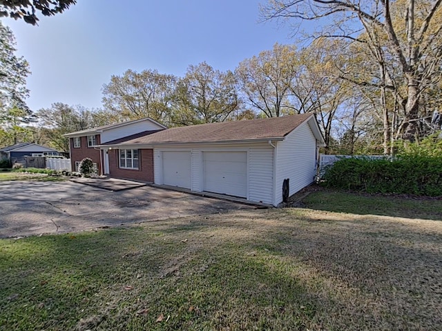 exterior space with aphalt driveway and fence