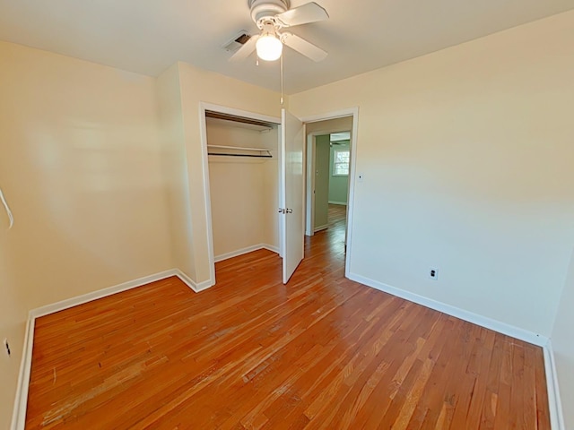 unfurnished bedroom with visible vents, baseboards, light wood-type flooring, and a closet