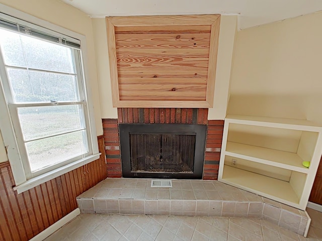 interior details featuring wooden walls and a fireplace