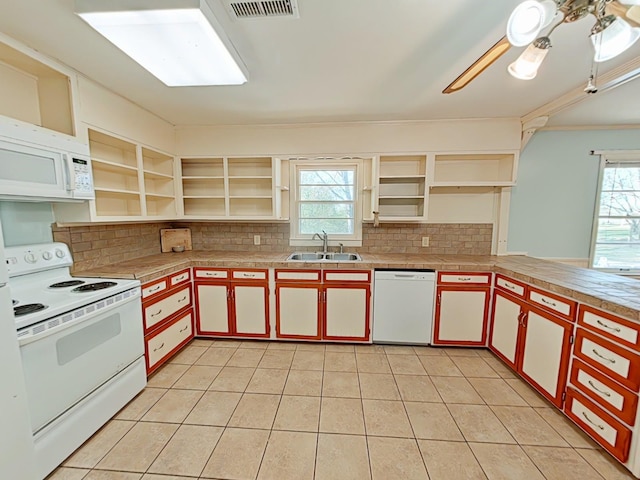 kitchen featuring white appliances, open shelves, a wealth of natural light, visible vents, and a sink