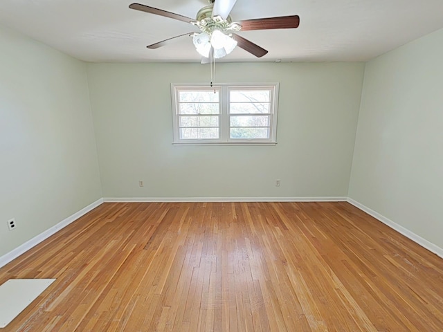unfurnished room with baseboards, light wood-type flooring, and ceiling fan