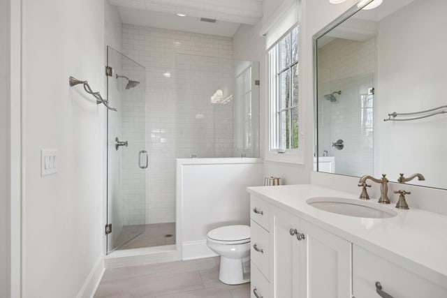 bathroom featuring tile patterned floors, toilet, a shower stall, and vanity