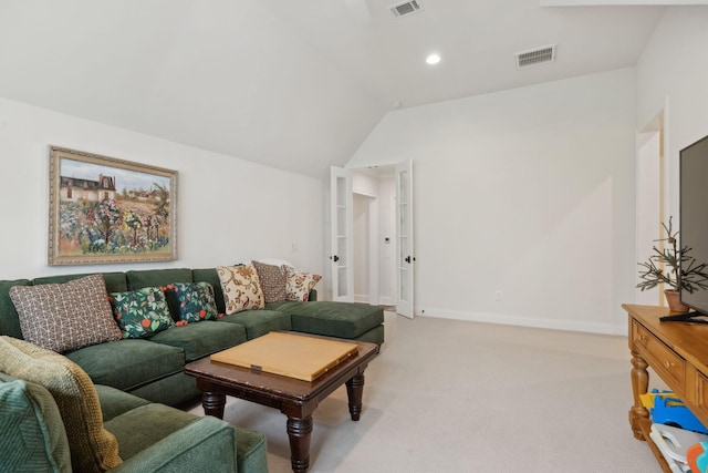 living area featuring light carpet, visible vents, baseboards, and vaulted ceiling
