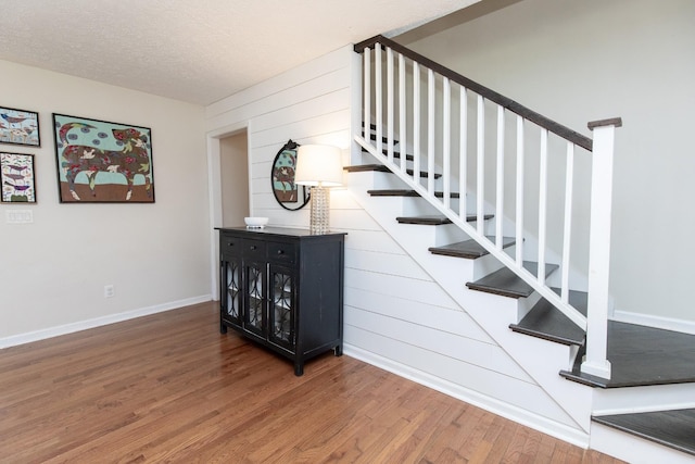 1411 Newmans Trl, Hendersonville, TN 37075 - stairs featuring wood finished floors, baseboards, a textured ceiling, and wood walls