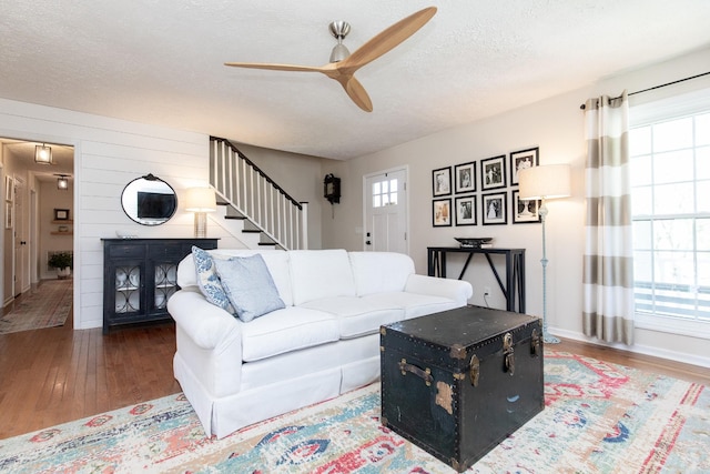 1411 Newmans Trl, Hendersonville, TN 37075 - living area featuring ceiling fan, stairs, wood finished floors, a textured ceiling, and a fireplace