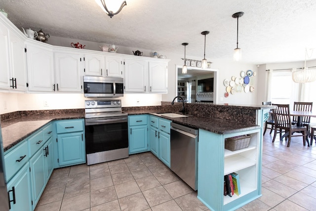 1411 Newmans Trl, Hendersonville, TN 37075 - kitchen featuring appliances with stainless steel finishes, a sink, blue cabinetry, a peninsula, and open shelves