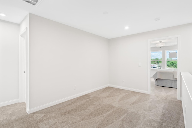 carpeted spare room with baseboards, visible vents, and recessed lighting