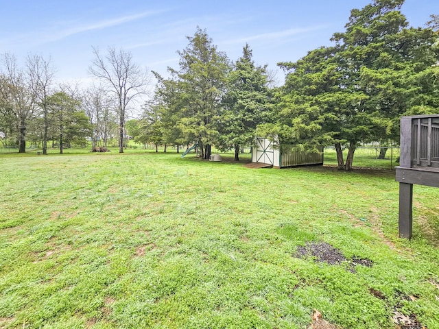 view of yard featuring an outbuilding and a shed