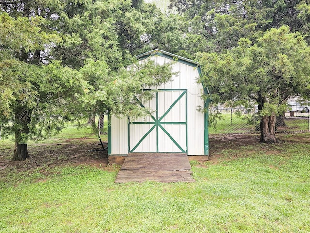 view of shed featuring fence