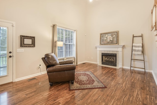 sitting room featuring visible vents, wood finished floors, and a healthy amount of sunlight