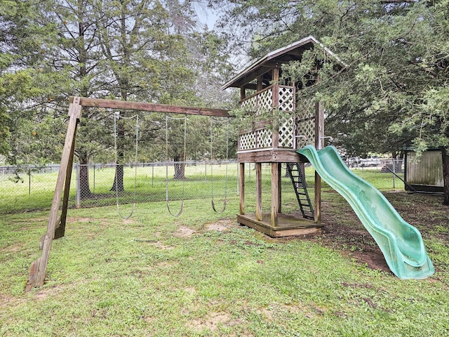 community playground featuring a yard and fence
