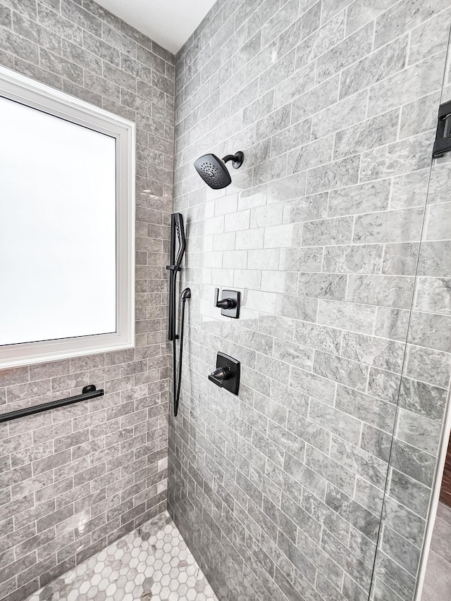 bathroom with a tile shower