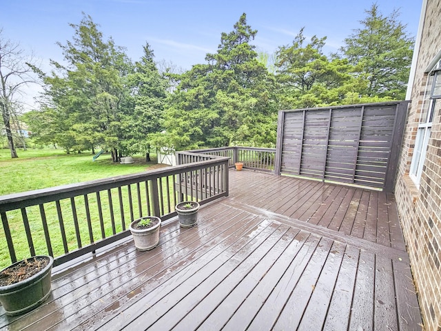 wooden deck featuring a yard