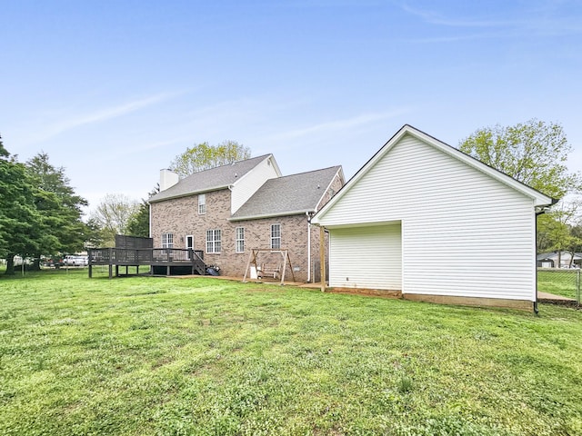 back of house featuring a yard and a wooden deck