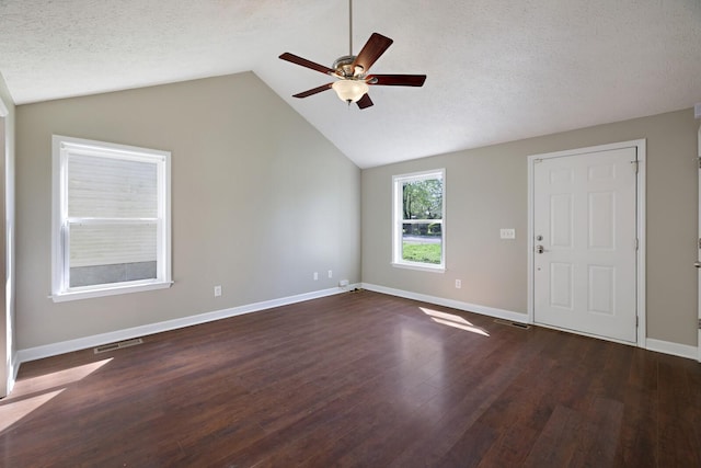 interior space with a textured ceiling, wood finished floors, a ceiling fan, and lofted ceiling