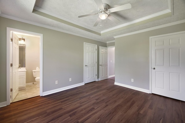 unfurnished bedroom featuring a tray ceiling and a textured ceiling