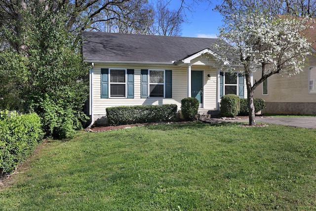 view of front of house featuring a front yard and roof with shingles