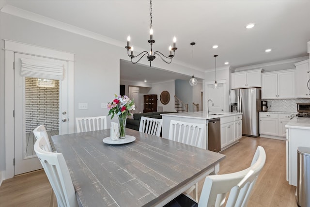 900 Easton Dr, Mount Juliet, TN 37122 - dining area with light wood-type flooring, an inviting chandelier, and ornamental molding