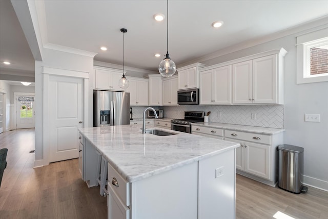 900 Easton Dr, Mount Juliet, TN 37122 - kitchen with white cabinets, a sink, ornamental molding, and appliances with stainless steel finishes
