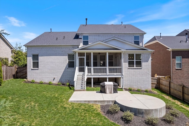 900 Easton Dr, Mount Juliet, TN 37122 - back of house featuring a sunroom, a yard, a fenced backyard, a patio, and brick siding