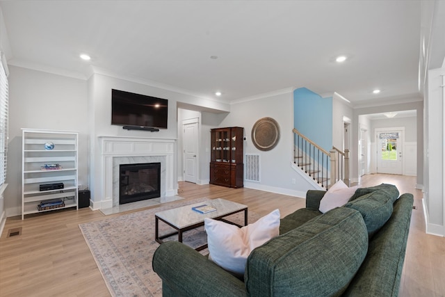 900 Easton Dr, Mount Juliet, TN 37122 - living area with light wood finished floors, a high end fireplace, visible vents, and stairway