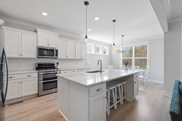 900 Easton Dr, Mount Juliet, TN 37122 - kitchen with tasteful backsplash, visible vents, a sink, appliances with stainless steel finishes, and crown molding