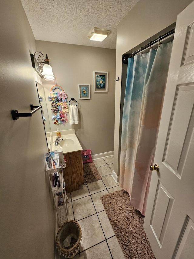 bathroom featuring tile patterned floors, a textured ceiling, curtained shower, and vanity
