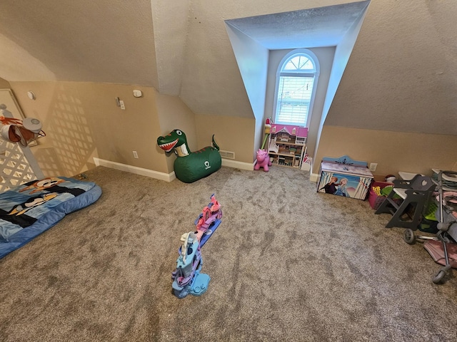 game room featuring a textured ceiling, carpet flooring, vaulted ceiling, and baseboards