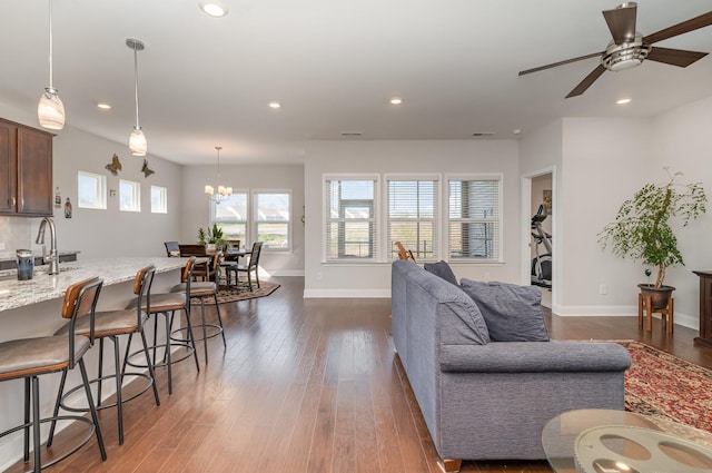 359 Mattieton Ln, Gallatin, TN 37066 - living room with ceiling fan with notable chandelier, baseboards, dark wood finished floors, and recessed lighting
