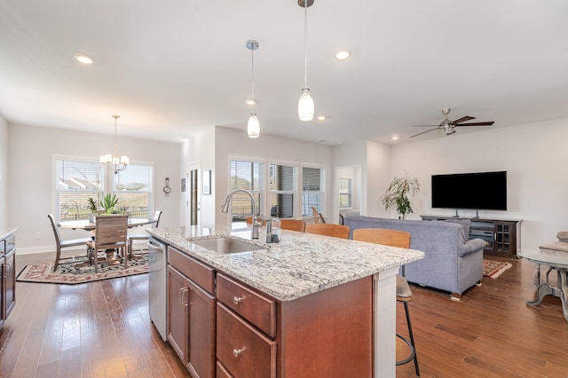 359 Mattieton Ln, Gallatin, TN 37066 - kitchen featuring a breakfast bar, open floor plan, dark wood-style floors, ceiling fan with notable chandelier, and a sink
