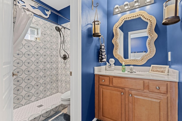 full bathroom featuring a shower stall, vanity, and toilet