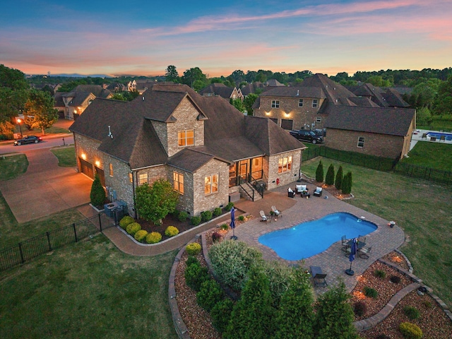 715 Farmington Dr, Lebanon, TN 37087 - back of house with a yard, driveway, and stone siding