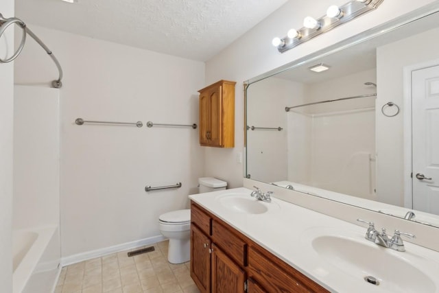 bathroom featuring visible vents, a textured ceiling, a sink, and toilet