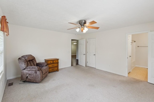 unfurnished room with visible vents, ceiling fan, carpet flooring, and baseboards