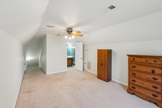 additional living space with ceiling fan, baseboards, vaulted ceiling, and visible vents