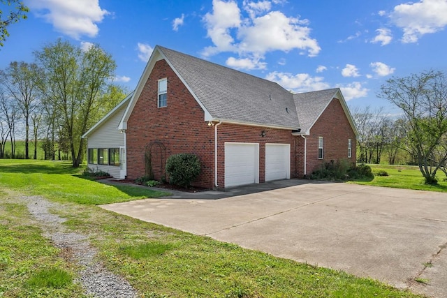 view of home's exterior with brick siding, a shingled roof, a yard, and concrete driveway