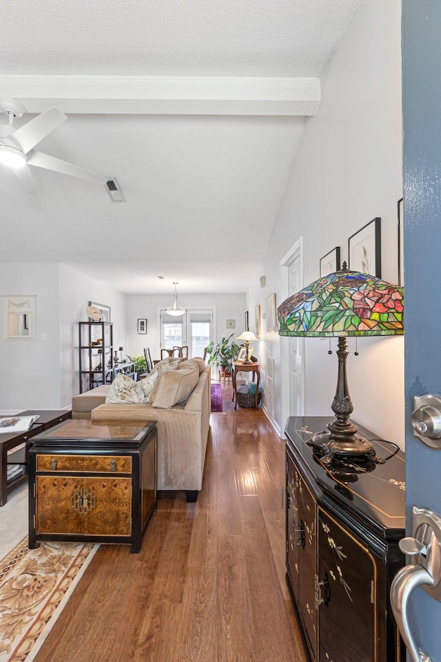 1304 Mallard Dr, Franklin, TN 37064 - living area with visible vents, vaulted ceiling with beams, a ceiling fan, and wood finished floors