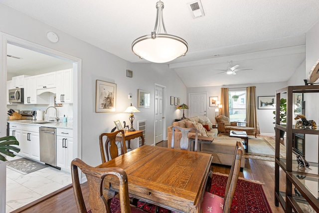 1304 Mallard Dr, Franklin, TN 37064 - dining room featuring visible vents, baseboards, lofted ceiling with beams, a ceiling fan, and wood finished floors