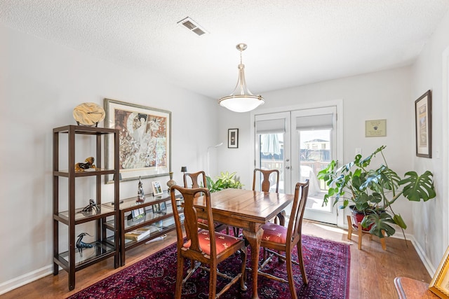 1304 Mallard Dr, Franklin, TN 37064 - dining space with visible vents, baseboards, a textured ceiling, wood finished floors, and french doors