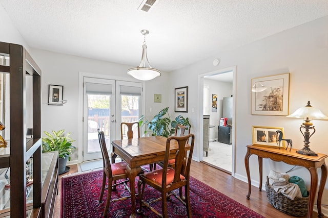 1304 Mallard Dr, Franklin, TN 37064 - dining room featuring visible vents, a textured ceiling, french doors, and wood finished floors